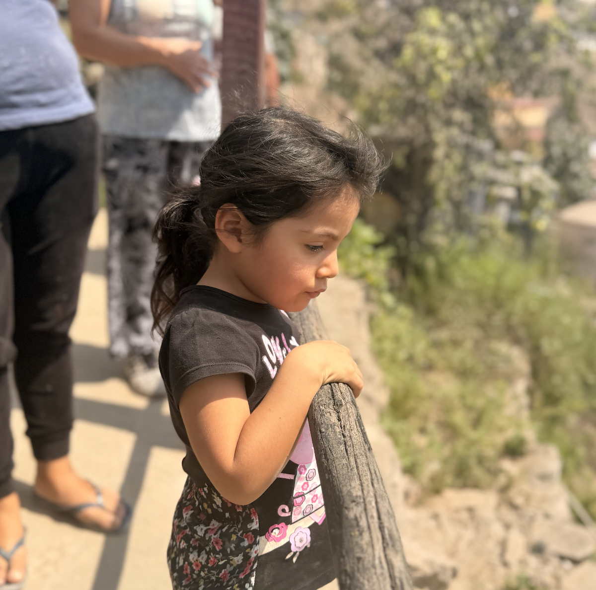 A girl looking out over the hillside community of Laderas de Amancaes, Lima